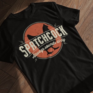 May include: Black t-shirt with a vintage-style graphic of a chicken and the text "SPATCHCOCK Always sounds dirty".