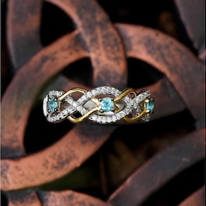 Collector’s Edition Enchanted Disney Brave 10th Anniversary Simulated Blue Topaz and Diamond Twist Ring in Sterling Silver8690