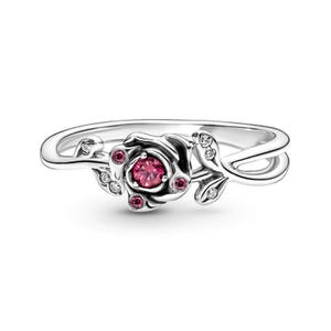 May include: A silver ring with a pink rose design. The rose has a pink gemstone in the center and smaller pink gemstones around it. The ring is set on a white background.