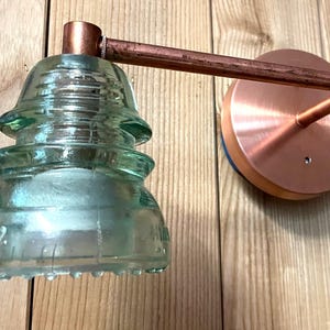 Vanity lights, vintage Glass Insulator bathroom vanity light.