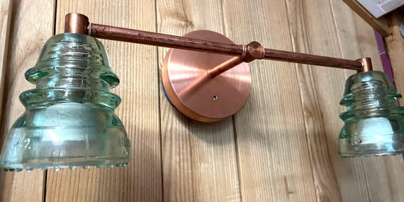 Vanity lights, vintage Glass Insulator bathroom vanity light.