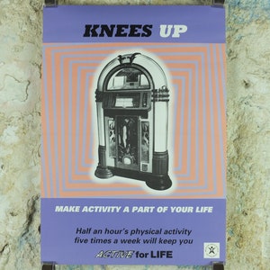 May include: Poster featuring a vintage jukebox illustration. The poster has a purple header with the words "KNEES UP" in black. Below the header is a retro design with a jukebox in the center. The poster promotes physical activity with the text "MAKE ACTIVITY A PART OF YOUR LIFE."