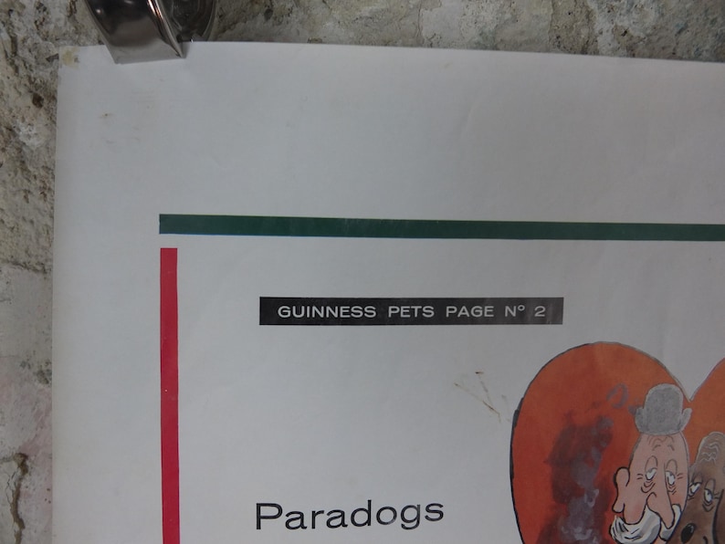 May include: A vintage poster with the text "GUINNESS PETS PAGE N&deg; 2" and the word "Paradogs". The poster features cartoon illustrations of dogs and people, with a red vertical stripe and a green horizontal stripe.