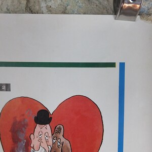 May include: A vintage comic illustration of two cartoon figures within a red heart shape. One figure wears a bowler hat. The artwork is on a white background with a green and blue border. A metal clip holds the top of the paper.
