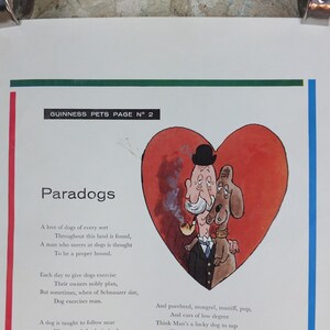 May include: A vintage print from the Guinness Pets series, with a cartoon illustration of a man and a dog inside a red heart. The text reads "Paradogs" and includes a poem about dogs. The print is held by silver clips.