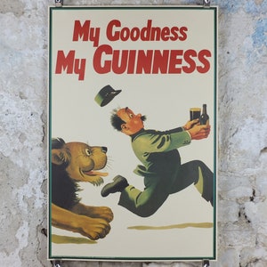 May include: Vintage Guinness poster with a cartoon illustration. A man runs with a pint of Guinness and a bottle, chased by a lion. The text "My Goodness My Guinness" is in red, a classic advertisement.