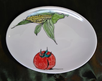 Vegetables on an oval shallow dish in white bone china. Sweetcorn and tomato