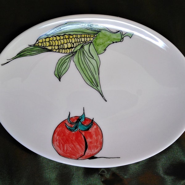 Vegetables on an oval shallow dish in white bone china. Sweetcorn and tomato