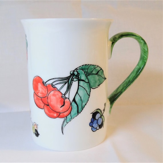 Mug white china hand decorated with fruit.