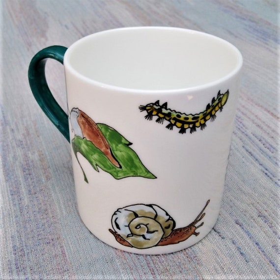 Garden creatures on a bone china mug.