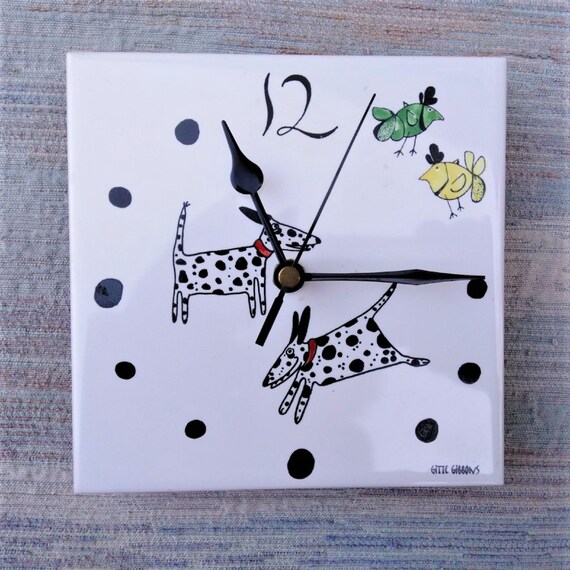 Dalmatian clock. A tile wall clock with spotty dog decoration and a battery quartz movement