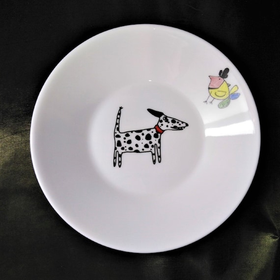 Small white china dish decorated with a happy Dalmatian and a bird.