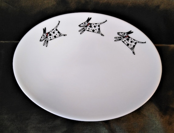 An oval shallow dish decorated with three amusing running Dalmatians. Useful as a side dish or a large and useful trinket tray.