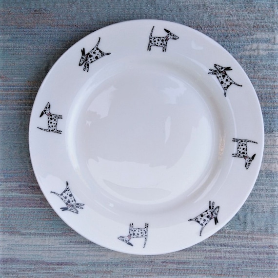 Side plate decorated with eight Dalmatians some running and some standing.