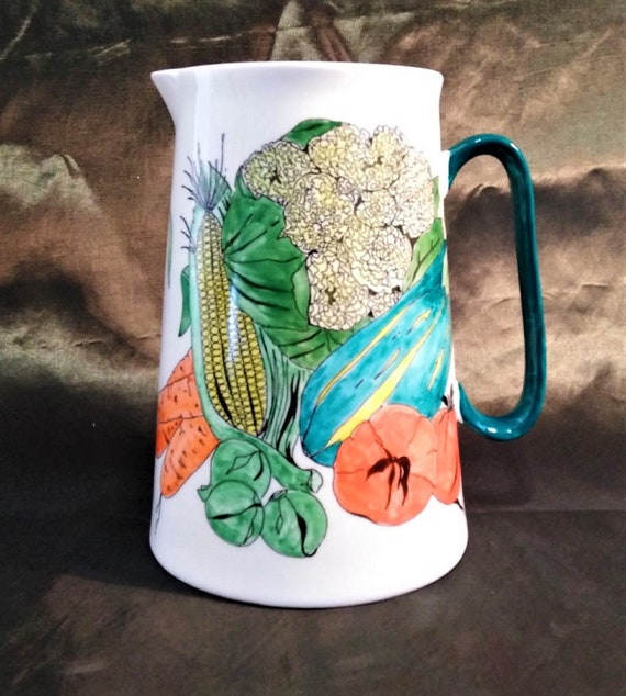 A glorious three pint china jug or pitcher covered with vegetables.