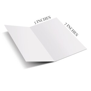 May include: A blank white card folded in half, measuring 7 inches by 5 inches. The card is lying flat on a white surface.