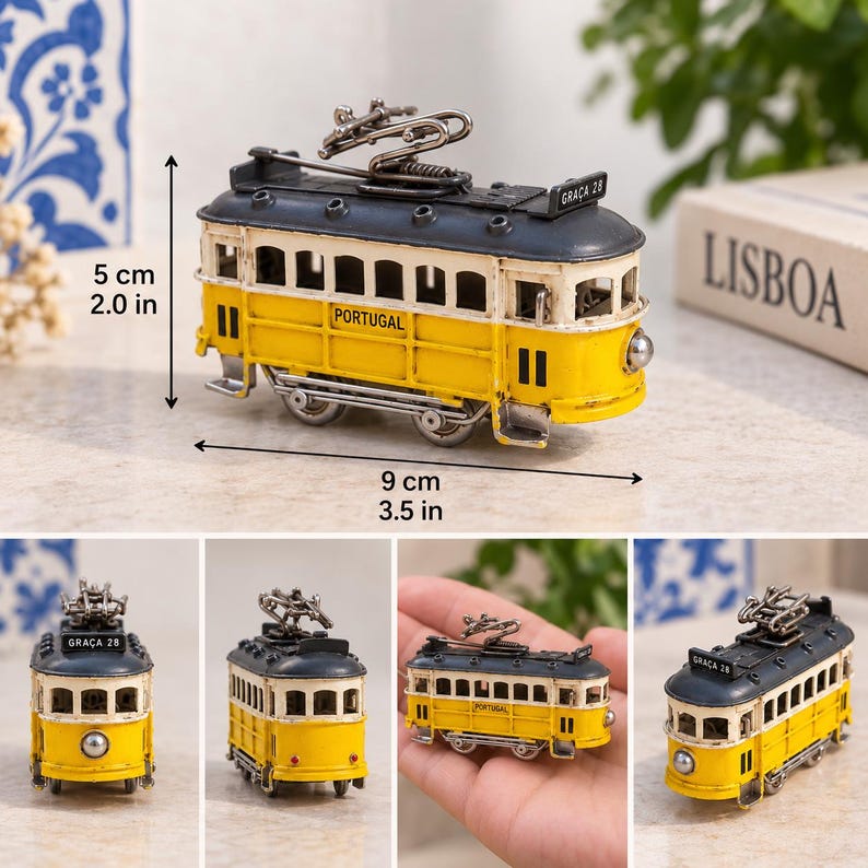 May include: A miniature yellow and dark gray tram model with the text PORTUGAL and GRA&Ccedil;A 28. The model measures 2.0 inches in height and 3.5 inches in length, featuring a roof-mounted pantograph, multiple windows, and small wheels on a metal frame.