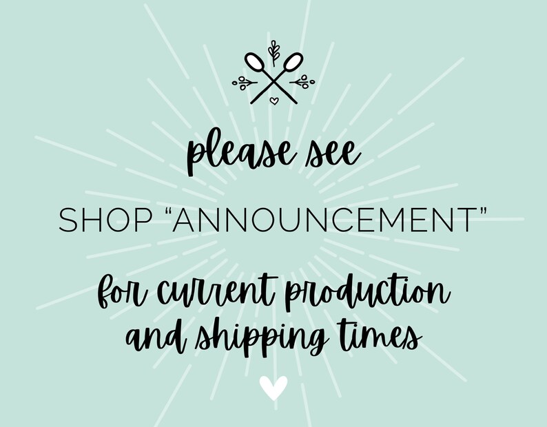 May include: A light blue background with white rays emanating from the center. The text "please see SHOP "ANNOUNCEMENT" for current production and shipping times" is written in black cursive font. A small heart is at the bottom of the image.