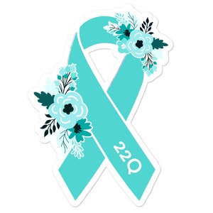May include: Teal blue ribbon with white text "22Q" and teal blue floral accents.