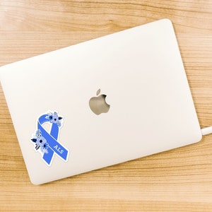 May include: A blue ribbon with white flowers and the word "ALS" on a white laptop.
