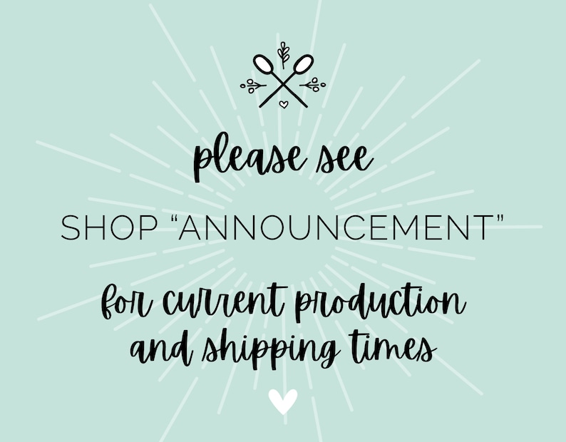 May include: A light blue background with white rays emanating from the center. The text "please see SHOP "ANNOUNCEMENT" for current production and shipping times" is written in black cursive font. A small heart is at the bottom of the image.