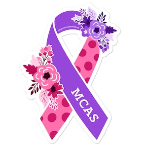 May include: Purple awareness ribbon with pink polka dots and floral accents. The ribbon has the text "MCAS" written on it.