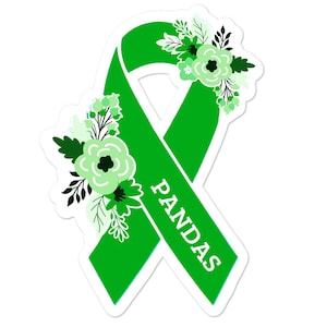 May include: Green awareness ribbon with white flowers and the word "PANDAS" written on it.