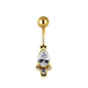 May include: Gold belly button ring with a teardrop-shaped clear crystal and smaller clear crystals around it.