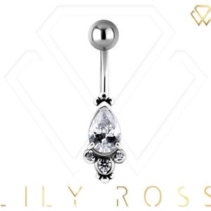 May include: Silver belly button ring with a teardrop-shaped clear crystal and smaller clear crystals around the bottom.