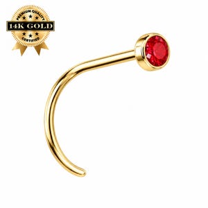 May include: A curved 14K gold nose stud featuring a round, faceted red gemstone set in a bezel. A gold seal graphic in the upper left corner displays the text PREMIUM QUALITY 14K GOLD CERTIFIED with star accents.