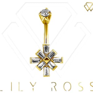 May include: Gold belly button ring with a clear crystal center and a starburst design with clear crystals.
