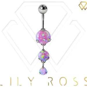 May include: A silver belly button ring with three pink opal-like stones. The stones are round and have a sparkly, iridescent finish.