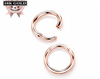 May include: Two rose gold-toned circular hoop rings with a hinged segment closure mechanism. One ring is shown in a closed position, while the other is slightly open. A circular badge in the top left corner displays the text 18K GOLD PREMIUM QUALITY.