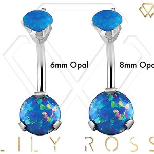May include: Two belly button rings with blue opal stones. The ring on the left has a 6mm stone and the ring on the right has an 8mm stone.