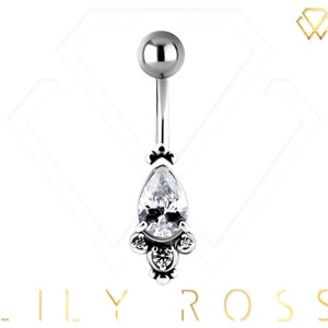 May include: Silver belly button ring with a teardrop-shaped clear crystal and smaller clear crystals around the edge.