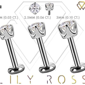 May include: Three silver-colored lip piercing studs with clear, round gemstones. The studs are 2mm, 2.5mm, and 3mm in size. The image includes the text "LILY ROSS" and "18K GOLD CERTIFIED".