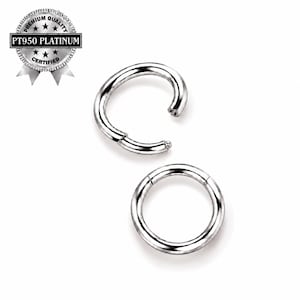 May include: Two circular PT950 platinum rings with a polished silver finish. One ring is fully closed, while the other is open with a hinged mechanism. A circular badge in the top left corner displays the text PREMIUM QUALITY PT950 PLATINUM CERTIFIED.