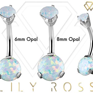 May include: Two silver belly button rings with opal stones. The ring on the left has a 6mm opal stone and the ring on the right has an 8mm opal stone.