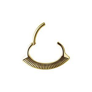 May include: Gold-toned body jewelry with a segmented, fan-shaped design. The jewelry is a circular hoop with a hinged opening.