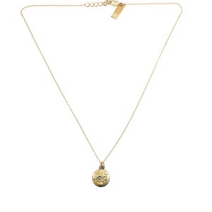 May include: A gold necklace with a round pendant that says "LOVE" in a textured font.