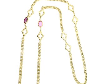 May include: A gold chain necklace with pink and purple oval-shaped stones. The chain is made of a double-link design with a clover-shaped accent.