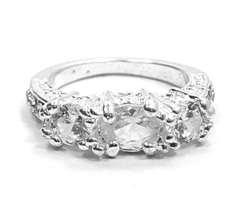 Eye Catching Silver Tone Ring with CZ Gemstones Size 6