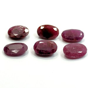 Peut inclure: Six pierres précieuses de rubis de forme ovale, d'une couleur rouge foncé. Les pierres précieuses sont facettées et ont une finition polie.