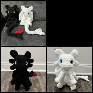 May include: Crocheted dragon plush toys in black and white. The black dragon has green eyes and a red fin. The white dragon has blue eyes. The toys are handmade and suitable for children.