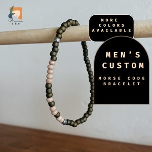 May include: A green and beige beaded bracelet with silver accents. The bracelet is a custom Morse code bracelet. The text "Men's Custom Morse Code Bracelet" is displayed on a black background.