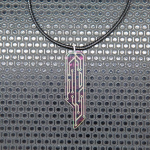 May include: A black cord necklace with a pendant shaped like a circuit board. The circuit board is pink and has a white outline.