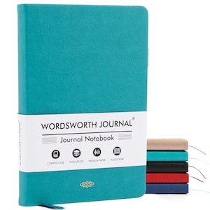 May include: A teal-colored journal with the text "WORDSWORTH JOURNAL" and "Journal Notebook" on a white band. The journal has a ribbon bookmark and is shown with a stack of other journals in various colors.