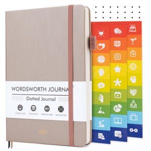 May include: A tan Wordsworth Dotted Journal with a matching elastic band closure. The journal includes a white label with the text "WORDSWORTH JOURNAL" and "Dotted Journal". Colorful sticker tabs with icons are visible.