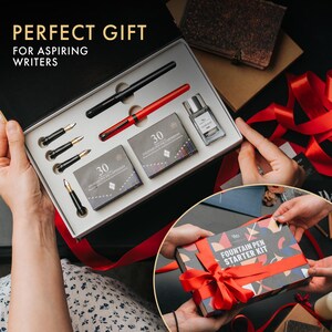 May include: A fountain pen starter kit with the text "PERFECT GIFT FOR ASPIRING WRITERS." The kit includes a black pen, a red pen, ink cartridges, and ink. The kit is presented in a black box with a red ribbon.
