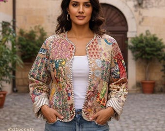 May include: A long-sleeved jacket featuring a multi-colored patchwork design with various floral and geometric patterns. The jacket has a round neckline, a front button closure, and white and black striped cuffs. The text shilpcraft is visible.